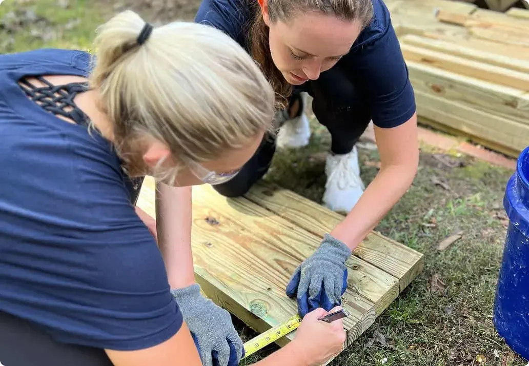 Two people working together on a wood project