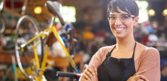 Small business owner in bike shop representing business loan financing